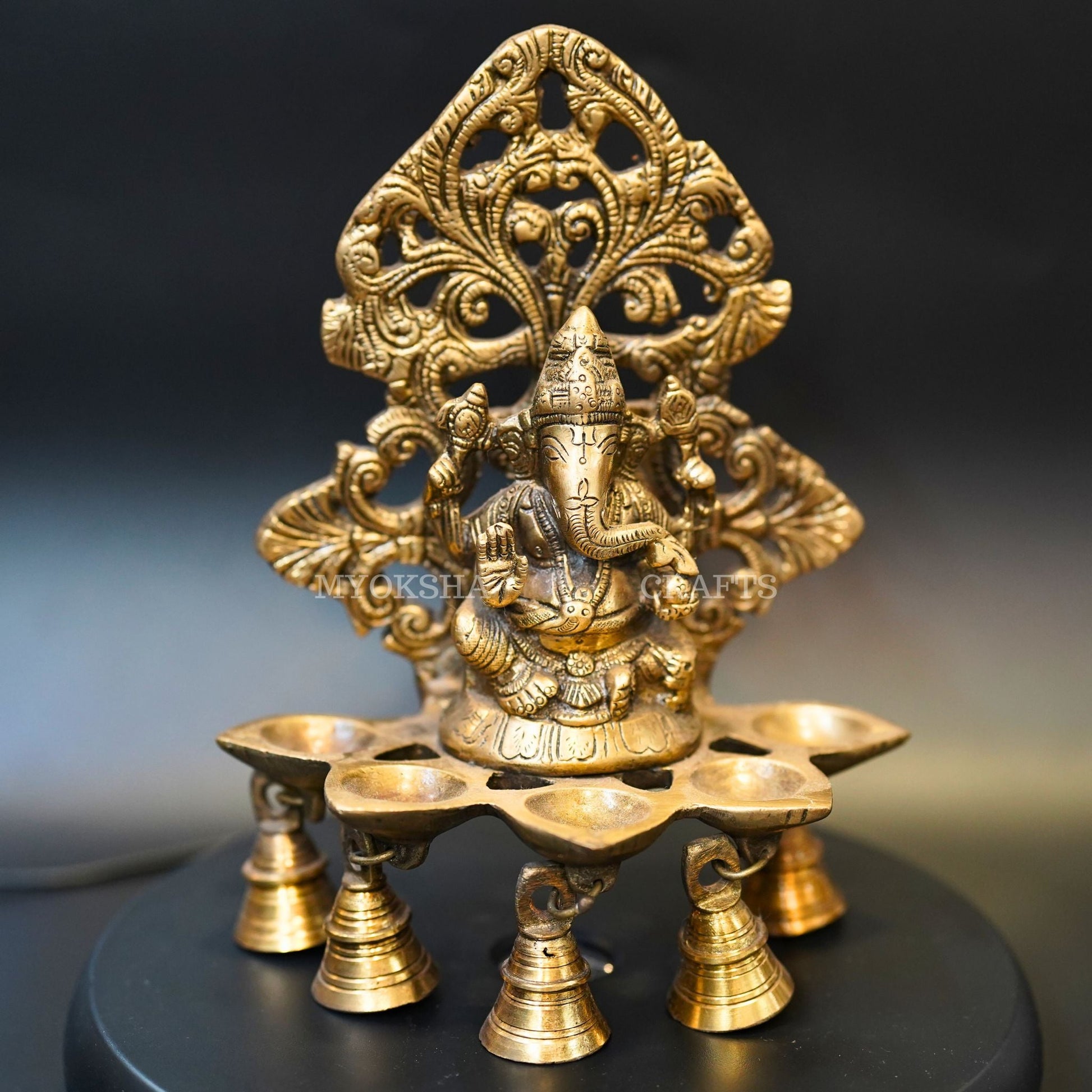 https://cdn.shopify.com/s/files/1/1857/6931/products/1692689127027_ganesha_5_oil_wick_vth_bells_diya_MC00331_281_29.png?v=1762395181