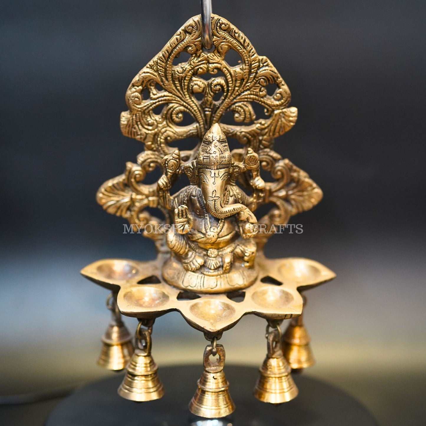 https://cdn.shopify.com/s/files/1/1857/6931/products/1692689130540_ganesha_5_oil_wick_vth_bells_diya_MC00331_283_29.png?v=1692946232