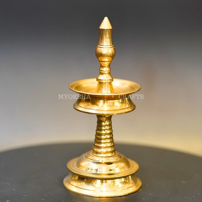 https://cdn.shopify.com/s/files/1/1857/6931/products/1692711919705_kerala_diya_MC00342.png?v=1753181944