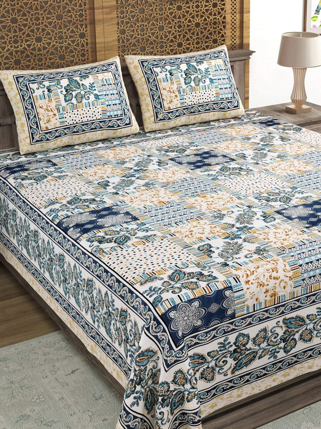 https://cdn.shopify.com/s/files/1/1857/6931/products/2427774d-709f-47d9-a511-9f6933a3f9e51689995146363SangriaBlueBrownPrinted210TCCottonDoubleKingBedsheetWithPill3.jpg?v=1703310142