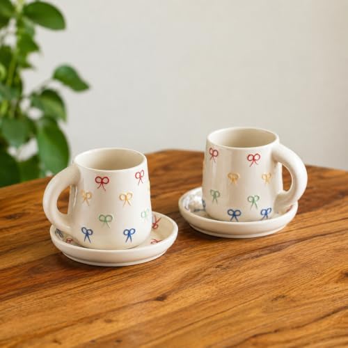 Image 1 of Default Title for the product ExclusiveLane Ribbon Bow Hand Embossed Ceramic Tea Cup with Saucer Set of 2 335 ml Microwave Safe