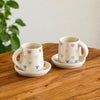 Image 1 of Default Title for the product ExclusiveLane Ribbon Bow Hand Embossed Ceramic Tea Cup with Saucer Set of 2 335 ml Microwave Safe