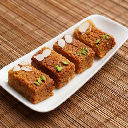 https://cdn.shopify.com/s/files/1/1857/6931/files/AgraSweetsAjmeriKalakand1-877152.jpg?v=1736144034