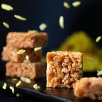 https://cdn.shopify.com/s/files/1/1857/6931/files/AlmondHousePoha_BhelChikkis00373_1_1.jpg?v=1765198893