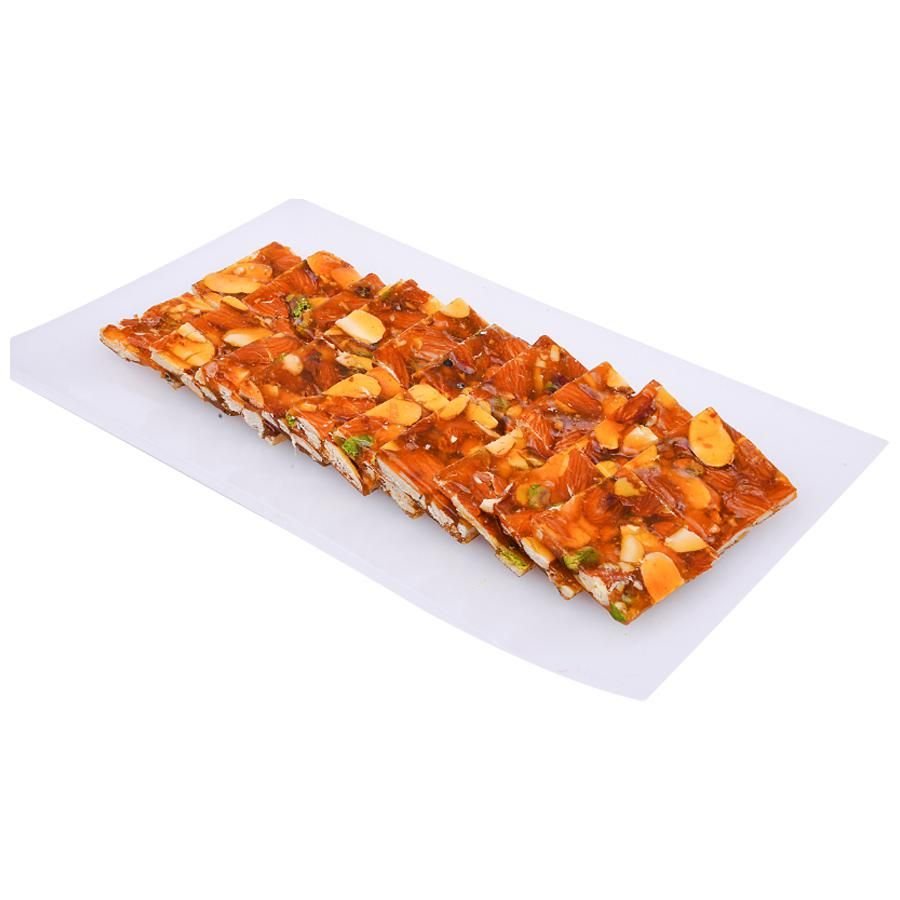 https://cdn.shopify.com/s/files/1/1857/6931/files/AshaSweetCenterDryFruitChikki-158702.jpg?v=1762275919