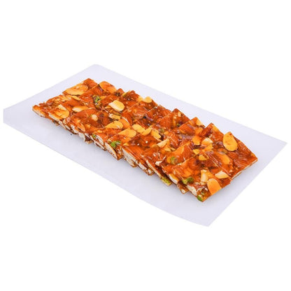 https://cdn.shopify.com/s/files/1/1857/6931/files/AshaSweetCenterDryFruitChikki-158702.jpg?v=1762275919