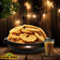 https://cdn.shopify.com/s/files/1/1857/6931/files/Front_view_of_Best_Kerala_snacks_online_arimurukku_in_a_bowl_english_-_Homemade_Kerala_snacks_crispy_rice_flour_spirals.webp?v=1746526854