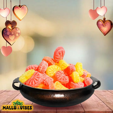 https://cdn.shopify.com/s/files/1/1857/6931/files/Front_view_of_Traditional_Kerala_food_Orange_mittai_in_a_bowl_english_-_Organic_Kerala_snacks_Orange_candy.webp?v=1746527671