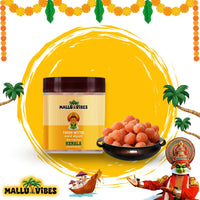 https://cdn.shopify.com/s/files/1/1857/6931/files/Front_view_of_package_with_bowl_Homemade_Kerala_snacks_thaen_mittai_in_a_bowl_english_-_Indian_snacks_kerala_sugar_honey_candy.webp?v=1746599905