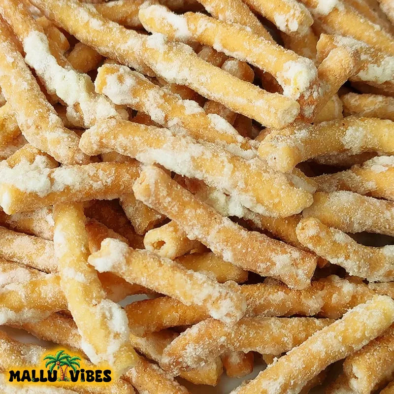 https://cdn.shopify.com/s/files/1/1857/6931/files/Top_view_of_Mallu_Vibes_Organic_Kerala_snacks_madhura_seva_in_a_bowl_english_-_sweet_sev_Buy_Kerala_Snacks_Online.webp?v=1767007633