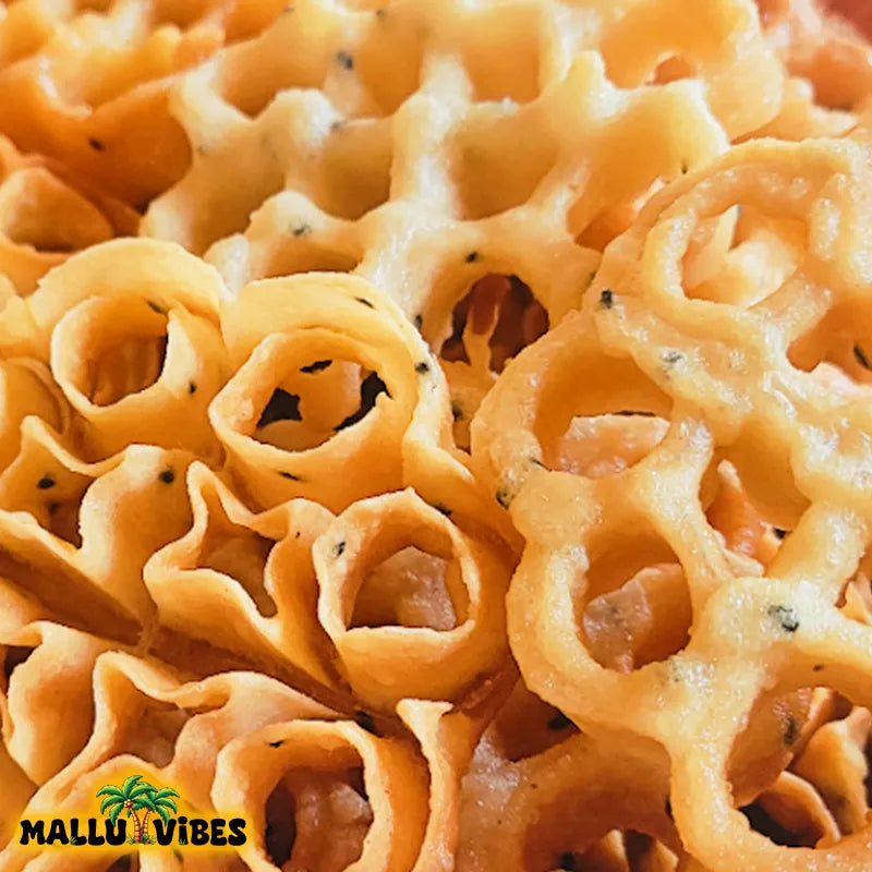 https://cdn.shopify.com/s/files/1/1857/6931/files/Top_view_of_Mallu_Vibes_Traditional_Kerala_food_Achappam_in_a_bowl_english_-_Homemade_Kerala_snacks_Achappam_kerala_rose_cookies_Indian_snacks.webp?v=1746526444