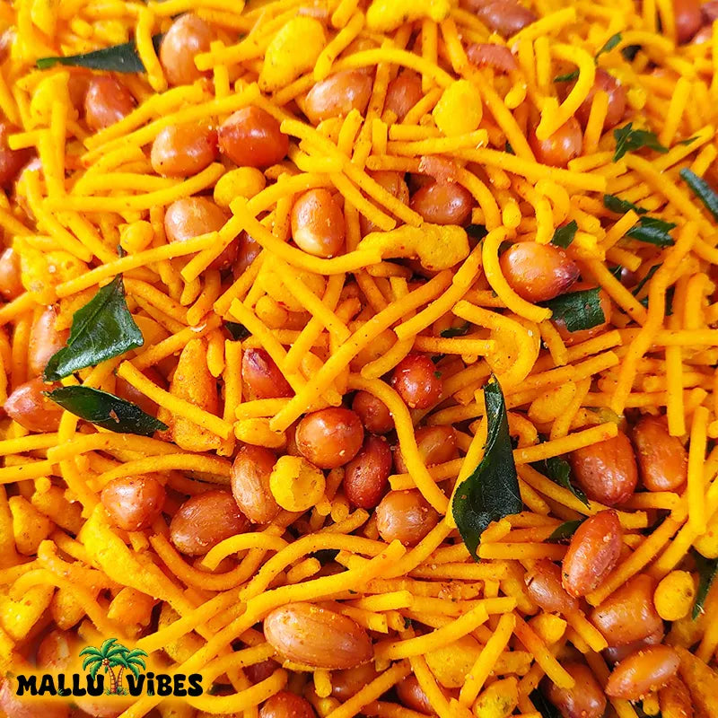 https://cdn.shopify.com/s/files/1/1857/6931/files/Top_view_of_package_design_crunchy_mixture_in_a_Mallu_Vibes_Organic_Kerala_snacks_malayalam_-_Kerala_snacks_chivada.webp?v=1767011508
