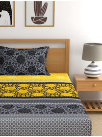 https://cdn.shopify.com/s/files/1/1857/6931/products/a118b77d-07d3-430e-81a2-faa0a532a4251694485508711DreamscapeYellowBlackEthnicMotifs140TCSingleBedsheetwith1Pil3.jpg?v=1703241843
