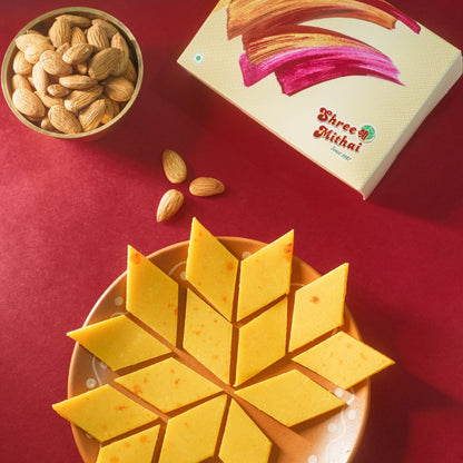 https://cdn.shopify.com/s/files/1/1857/6931/files/kesar-kaju-katli-983547.jpg?v=1762168998